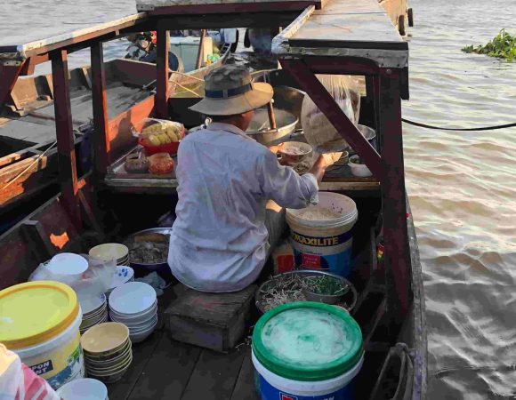 Bun Bo seller in authentic Cai Rang floating market of the Mekong Delta