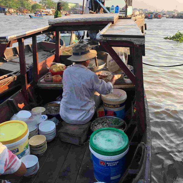 Bun Bo seller in authentic Cai Rang floating market of the Mekong Delta